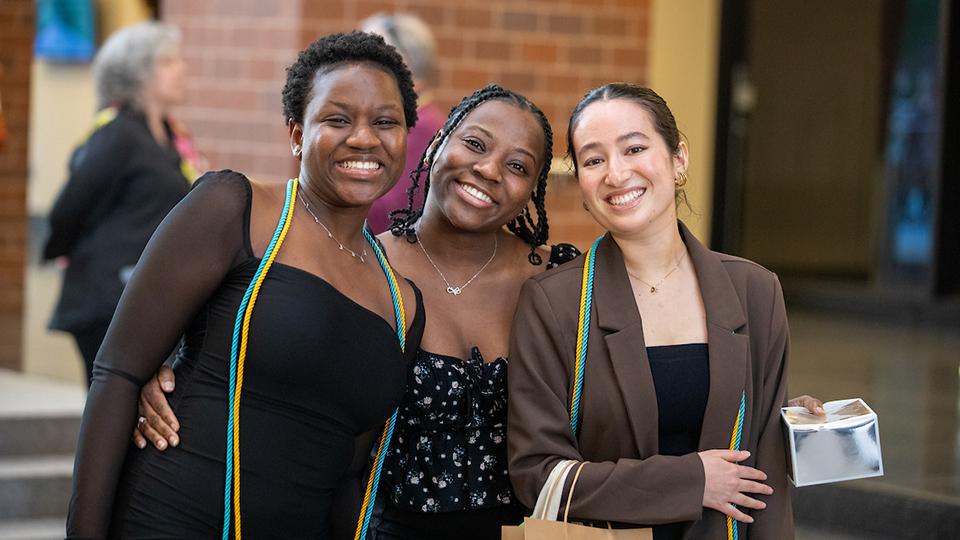 Group of 3 students grinning at the camera