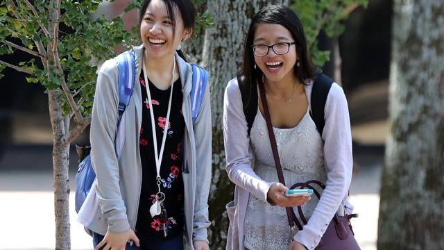 Two students walking on campus on the first day of classes.